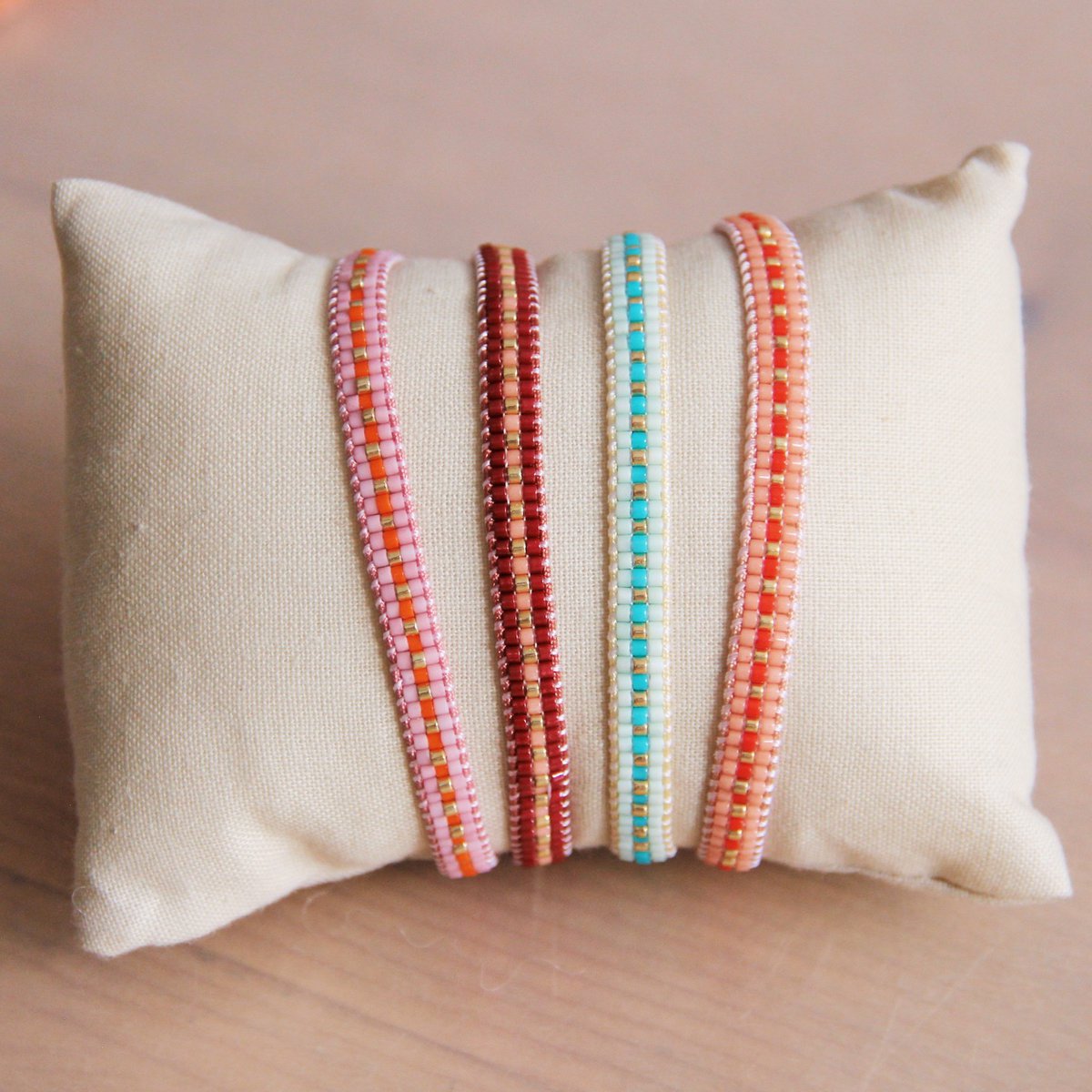 Gevlochten armband bordeaux/perzik/verguld