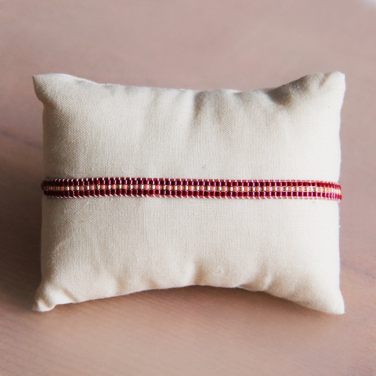 Gevlochten armband bordeaux/perzik/verguld
